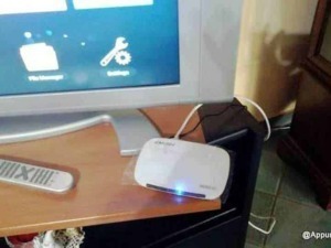 Televisore con dispositivi di streaming e telecomando sul tavolo, tecnologia smart home, intrattenimento digitale, dispositivi elettronici, configurazione tecnologia.
