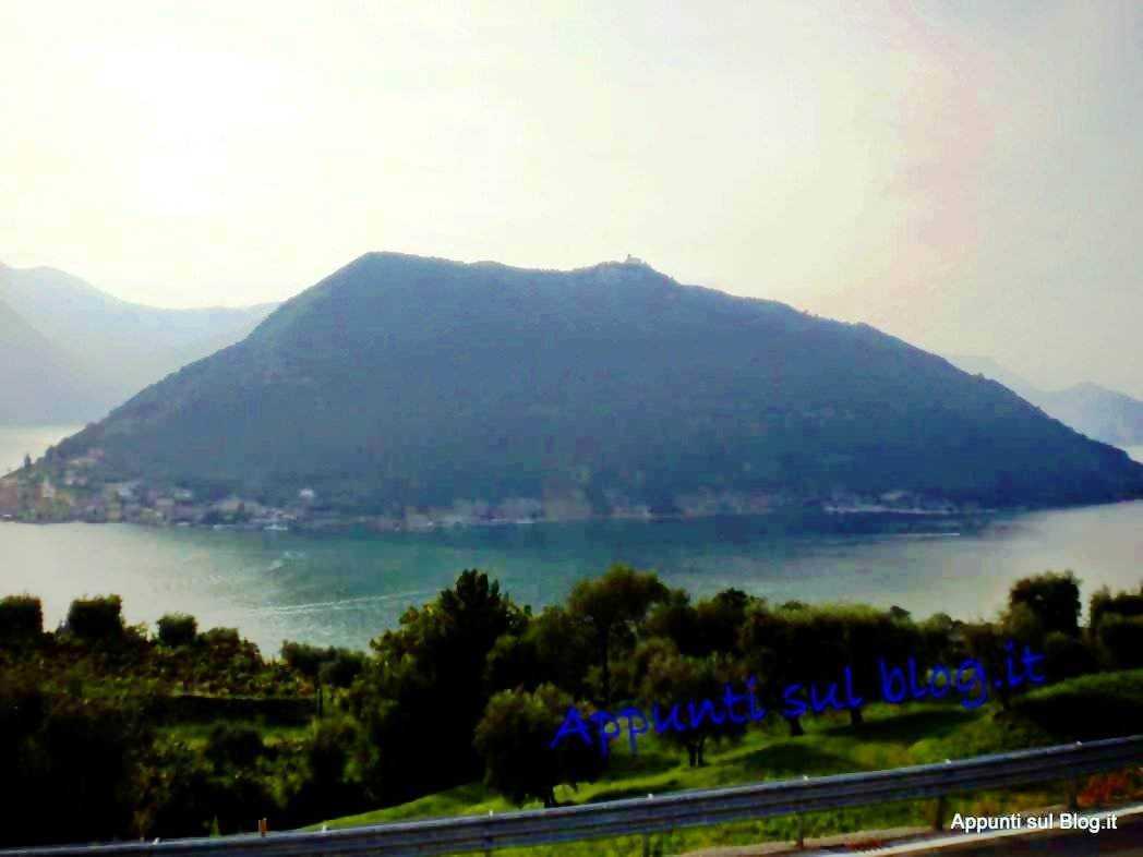 Lago d'Iseo cosa vedere: guida al lungolago e Montisola 2026. Lungolago con vegetazione verde e paesaggio tranquillo.