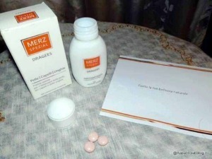 Merz Spezial dragees integratori per la pelle capelli e unghie, in confezione e scatola su tovaglia, con foglio di carta con scritta "Eccati la tua bellezza naturale".