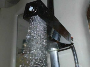 Diffusore doccia moderno con acqua che scorre, design elegante e funzionale per bagno, rubinetto doccia con getto morbido, accessorio bagno di alta qualità, installazione facile.