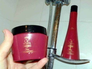 LATHER SHAMPOO AND CONDITIONER HAIR CARE PRODUCTS IN BATHROOM SHOWER .