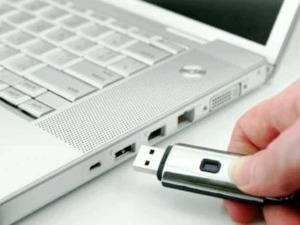 Pen drive USB collegato a laptop bianco, tecnologia digitale, trasferimento dati, connettività, dispositivi informatici per il backup.