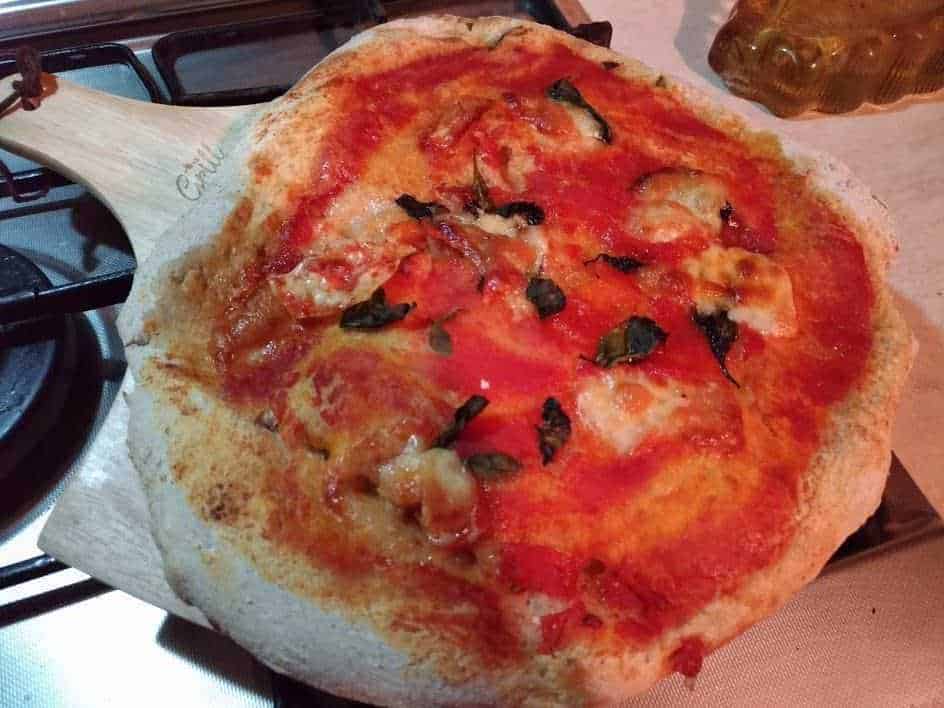 Crosta di pizza napoletana con pomodoro, mozzarella, basilico fresco e olio d'oliva. Pasta morbida e irresistibile, perfetta per gustare una vera pizza italiana fatta in casa o in pizzeria. Olimpo delle pizze tradizionali.