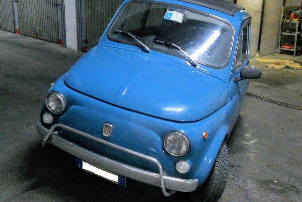 Fiat 500 blue vintage microcar parked in a garage, classic Italian city car, compact and retro design, perfect for urban driving.