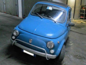Fiat 500 blue vintage microcar parked in a garage, classic Italian city car, compact and retro design, perfect for urban driving.