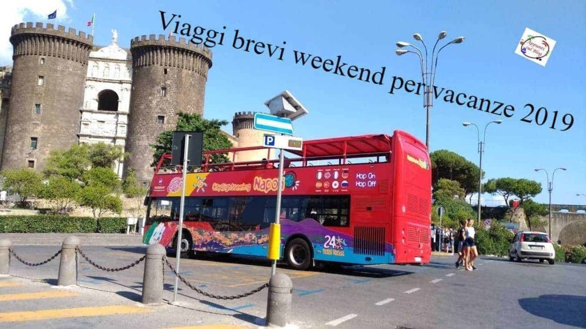 Mercatini di natale: Autobus turistico rosso a Roma con il Castello di Sant'Angelo sullo sfondo, scena di viaggio breve e vacanze 2019 in Italia, veicolo per tour turistici e attrazioni storiche.
