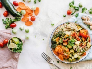 Verdure fresche, quinoa e legumi in un piatto salutare con ingredienti naturali, ideale per una dieta equilibrata e ricca di vitamine, presentato in modo appetitoso e colorato.
