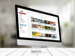 YouTube interface on iMac displaying various suggested videos in a grid format.