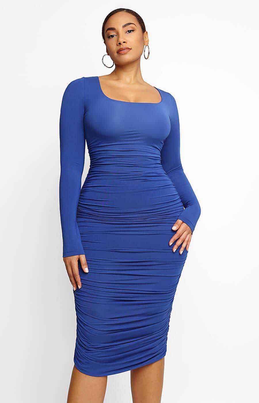 Abito modellante: come scegliere lo stile giusto 3 Abito modellante blu drappeggiato, maniche lunghe e scollo squadrato, elegante e alla moda.
