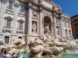 Fountain of the Trevi Palace, a famous Baroque masterpiece in Rome, featuring intricate sculptures and cascading water, popular tourist attraction and symbol of Italy.