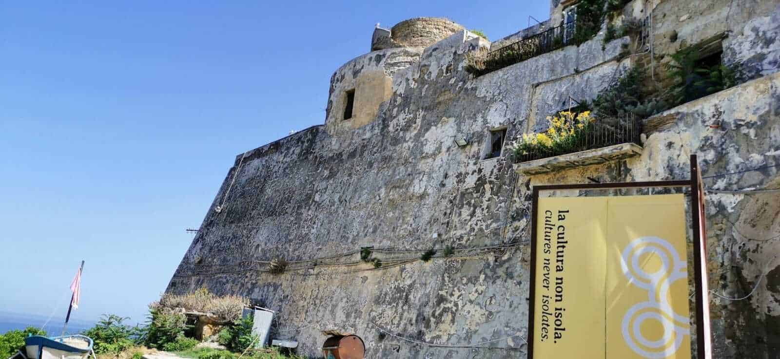 Antica fortezza sul mare con muri in pietra e vista panoramica, simbolo di cultura e storia nel cuore di un paesaggio mediterraneo. Ideale per esplorare le radici storiche delle città costiere italiane.