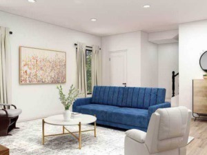Comfortable soggiorno moderno con divano blu, poltrona in tessuto chiaro, tavolino centrale e decorazioni eleganti, alimentato da luce naturale, ideale per relax e socializzazione.