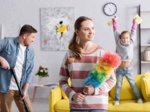 Pulizia di casa, famiglia felice, vita quotidiana in soggiorno con bambini, pulizia, spazzola multicolore, ambienti domestici, cura della casa, momenti di famiglia.