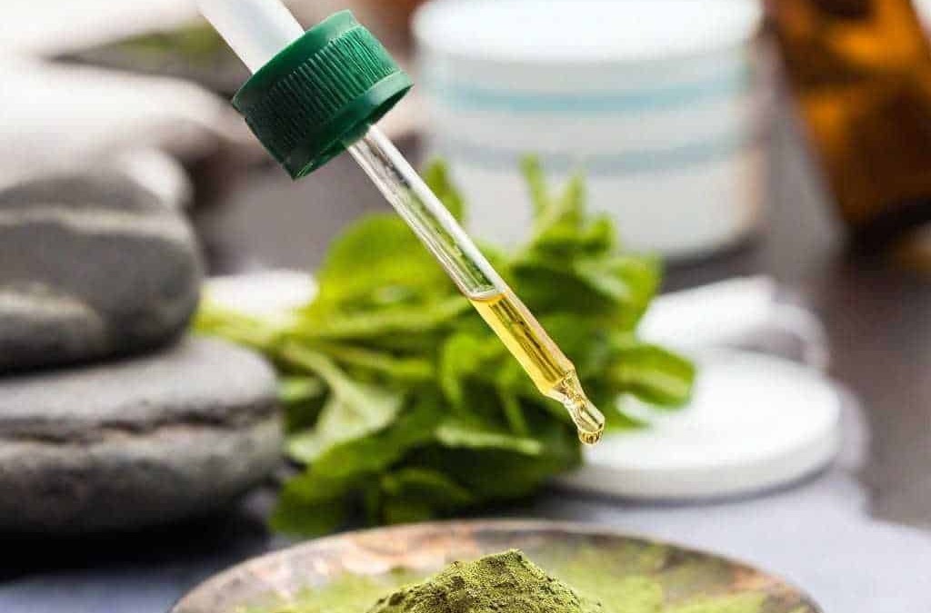 Polvere di erba di spirulina in una ciotola, con un contagocce e contro luce, ambientata in uno studio di medicina alternativa, centrata sul benessere naturale e le proprietà nutrizionali.