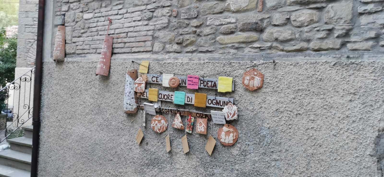 Portico di Romagna il paese di Dante e Beatrice 4 Creativa decorazione su parete con citazioni e ornamenti artigianali in terracotta, proveniente da Appunti Sul Blog, perfetta per ispirare poesia e creatività all'aperto.