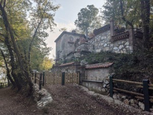 Scorcio di Monticelli Brusati in Lombardia, con sentiero e antica villa in pietra immersa nel verde, ideale per escursioni e turismo culturale.