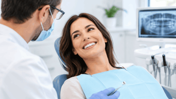 Paziente dal sorriso naturale durante una visita in uno studio dentistico moderno.